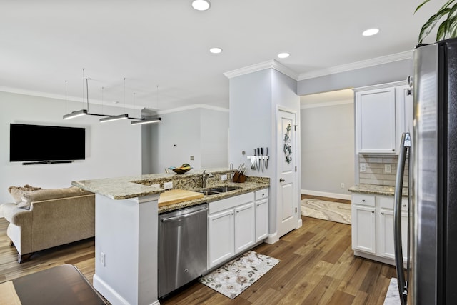 kitchen featuring white cabinets, dark hardwood / wood-style floors, tasteful backsplash, light stone counters, and stainless steel appliances