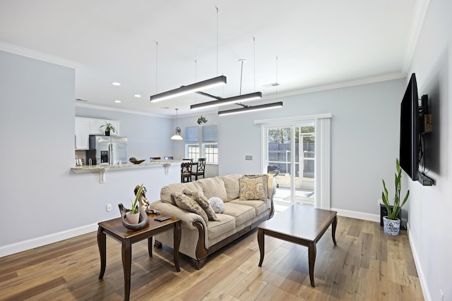 living room with crown molding and light wood-type flooring