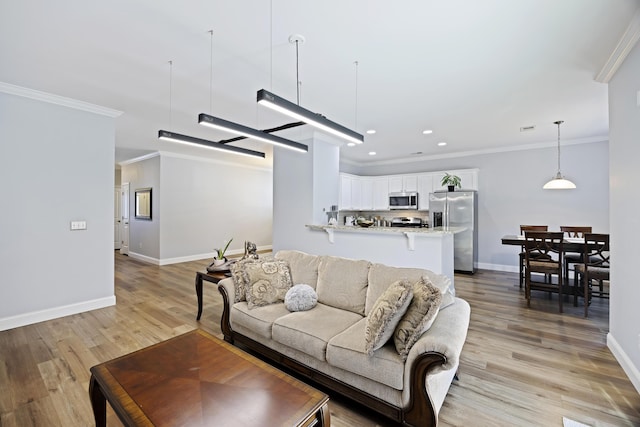 living room featuring light wood-type flooring and crown molding