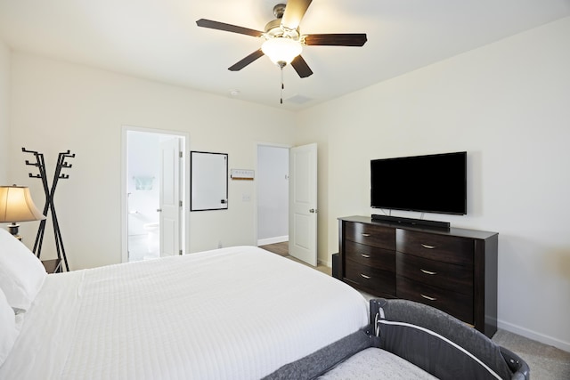 carpeted bedroom featuring connected bathroom and ceiling fan