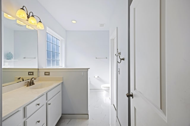 bathroom featuring vanity and toilet