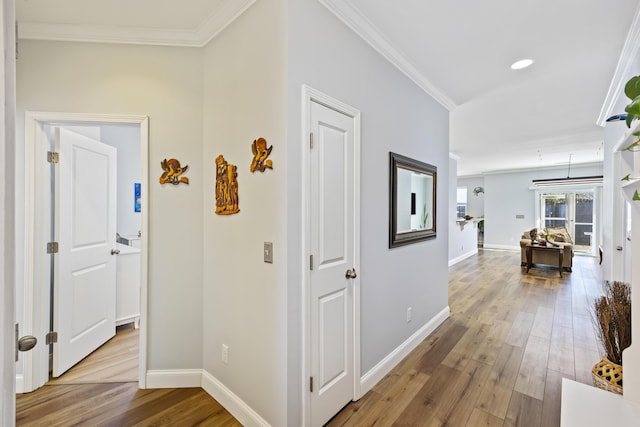 hall with crown molding and light wood-type flooring