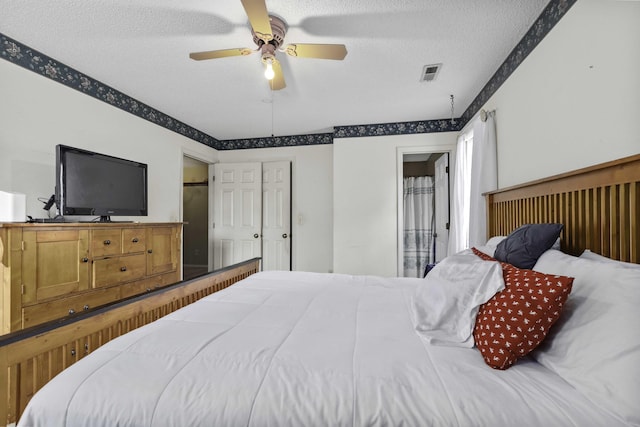 bedroom with connected bathroom, ceiling fan, and a textured ceiling