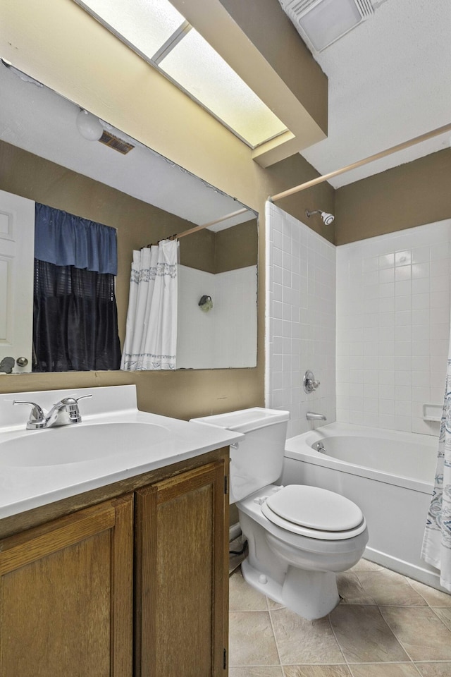 full bathroom featuring tile patterned flooring, vanity, shower / bath combo, and toilet