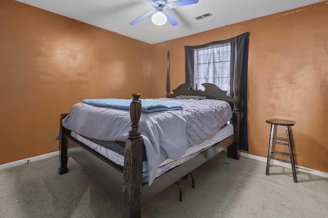 bedroom featuring a textured ceiling, ceiling fan, and carpet flooring