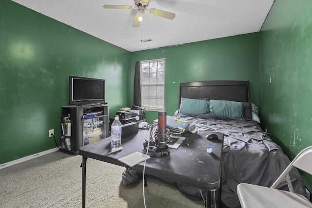 bedroom featuring ceiling fan, carpet, and a textured ceiling