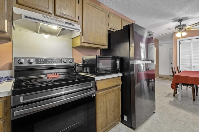 kitchen with ceiling fan, stainless steel appliances, and a textured ceiling