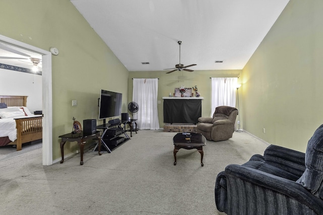 living room with ceiling fan, light colored carpet, and vaulted ceiling