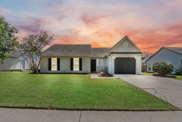 single story home with a lawn and a garage