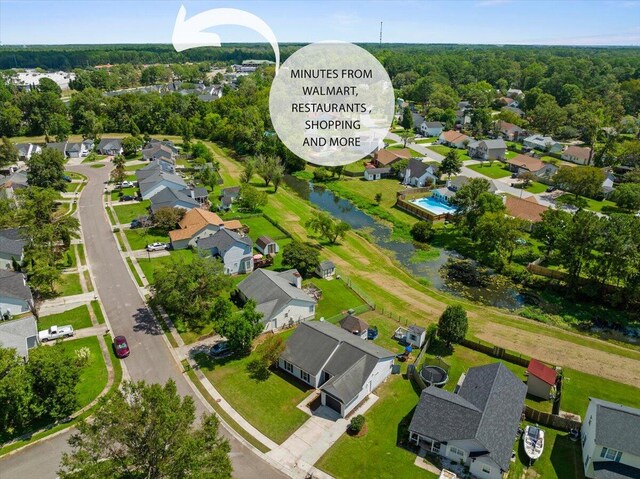 birds eye view of property with a forest view and a residential view