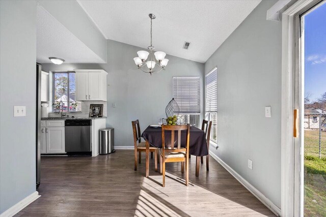 dining area with a wealth of natural light, lofted ceiling, dark wood-style flooring, and a notable chandelier