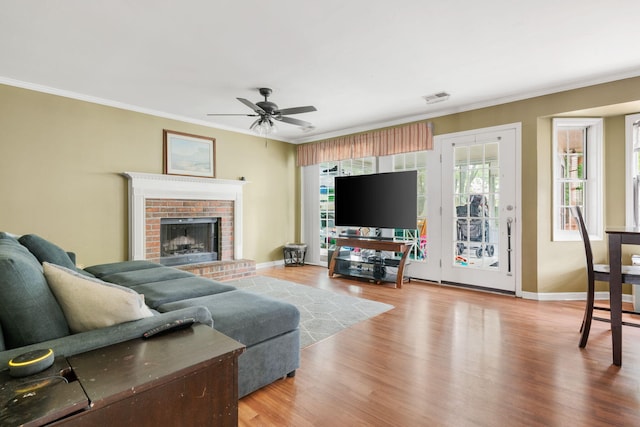 103 Retriever Ln, Goose Creek, SC 29445 - living room with wood finished floors, crown molding, ceiling fan, a brick fireplace, and baseboards