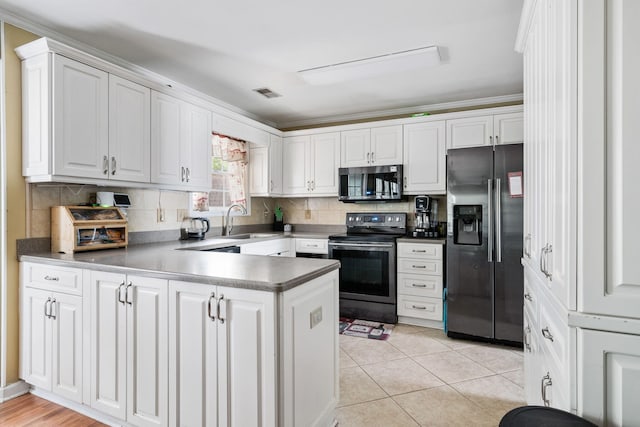 103 Retriever Ln, Goose Creek, SC 29445 - kitchen featuring refrigerator with ice dispenser, range with electric cooktop, stainless steel microwave, a sink, and white cabinetry