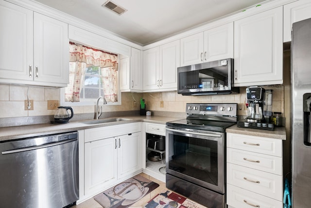 103 Retriever Ln, Goose Creek, SC 29445 - kitchen with appliances with stainless steel finishes, a sink, white cabinetry, and backsplash