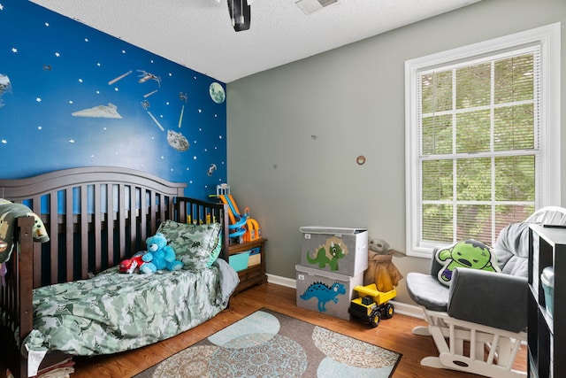 103 Retriever Ln, Goose Creek, SC 29445 - bedroom with wood finished floors, baseboards, and a textured ceiling