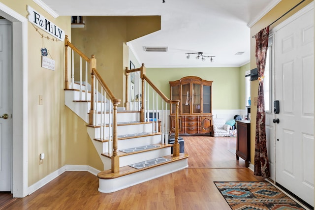 103 Retriever Ln, Goose Creek, SC 29445 - foyer featuring wood finished floors, stairway, crown molding, a wainscoted wall, and rail lighting