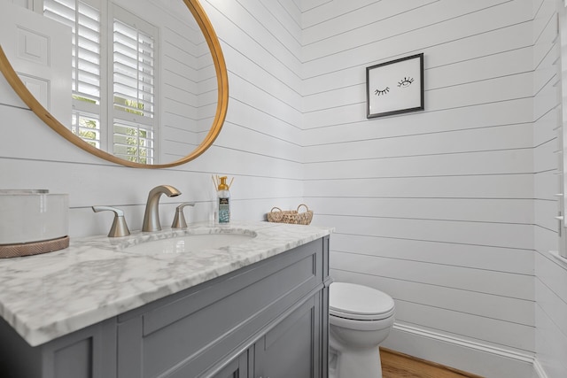 228 Beresford Creek St, Charleston, SC 29492 - bathroom featuring vanity, wood walls, and wood finished floors