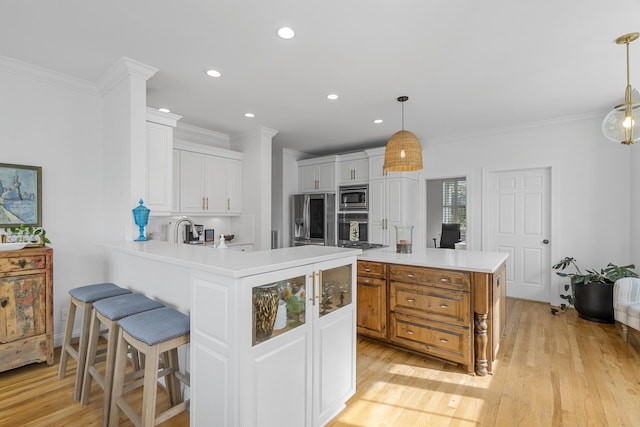 228 Beresford Creek St, Charleston, SC 29492 - kitchen with stainless steel appliances, crown molding, light countertops, white cabinetry, and light wood finished floors