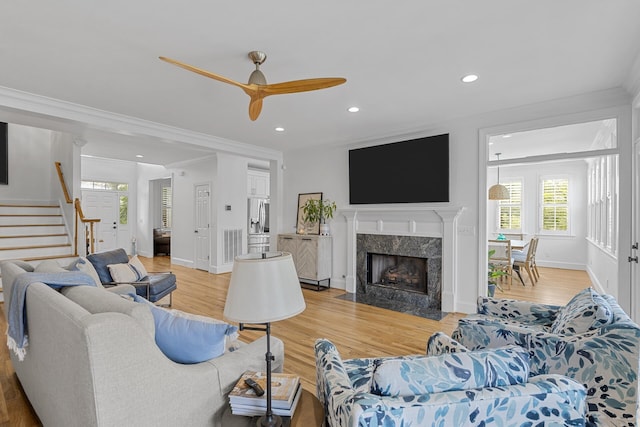228 Beresford Creek St, Charleston, SC 29492 - living room featuring stairs, a high end fireplace, healthy amount of natural light, recessed lighting, and light wood-style floors