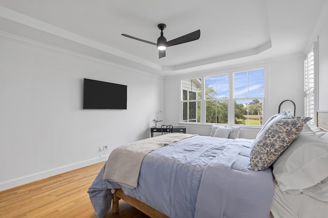 228 Beresford Creek St, Charleston, SC 29492 - bedroom with a raised ceiling, wood finished floors, multiple windows, and a ceiling fan