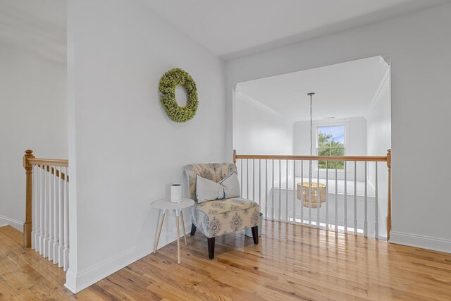 228 Beresford Creek St, Charleston, SC 29492 - living area with wood finished floors, an upstairs landing, and crown molding
