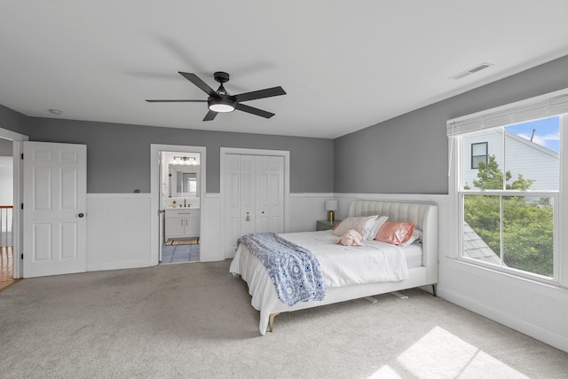 228 Beresford Creek St, Charleston, SC 29492 - carpeted bedroom with wainscoting, ensuite bath, a closet, and ceiling fan