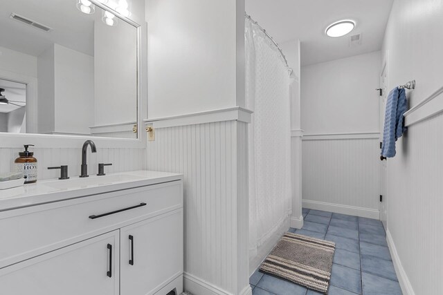 228 Beresford Creek St, Charleston, SC 29492 - bathroom featuring a wainscoted wall, tile patterned flooring, vanity, and ceiling fan