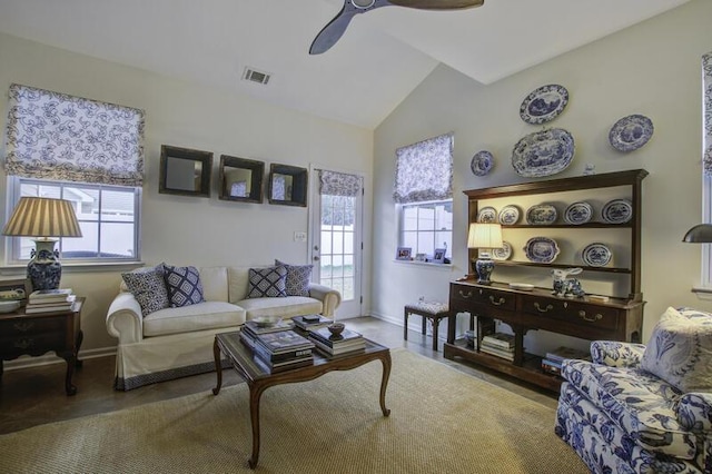 living room with ceiling fan, a healthy amount of sunlight, and lofted ceiling