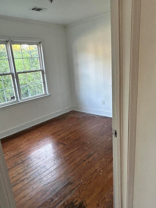 spare room with dark wood-type flooring