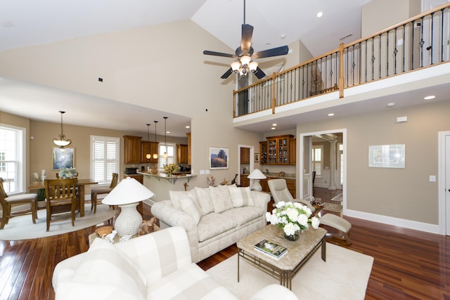 living room featuring ceiling fan, high vaulted ceiling, and dark hardwood / wood-style floors