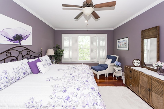 bedroom with crown molding, hardwood / wood-style flooring, and ceiling fan