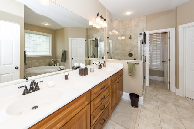 bathroom featuring vanity, tile patterned floors, and separate shower and tub