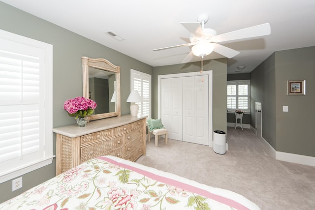 carpeted bedroom with a closet and ceiling fan