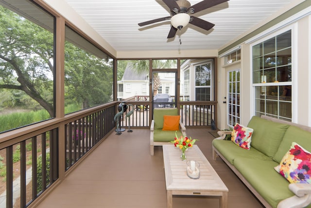 sunroom featuring ceiling fan and plenty of natural light