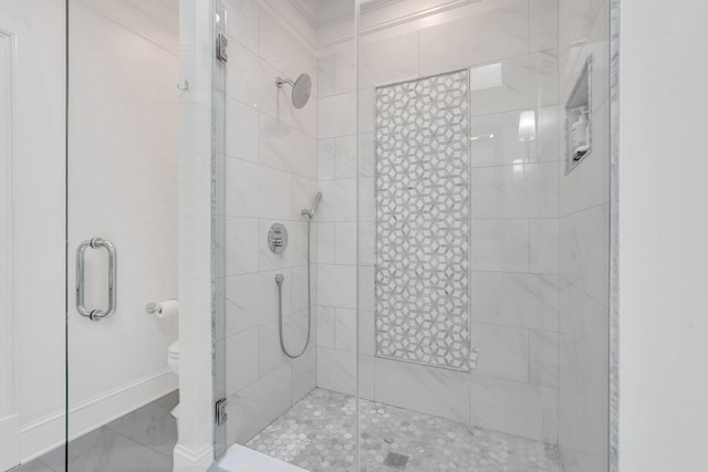 full bath with a shower stall, toilet, and baseboards