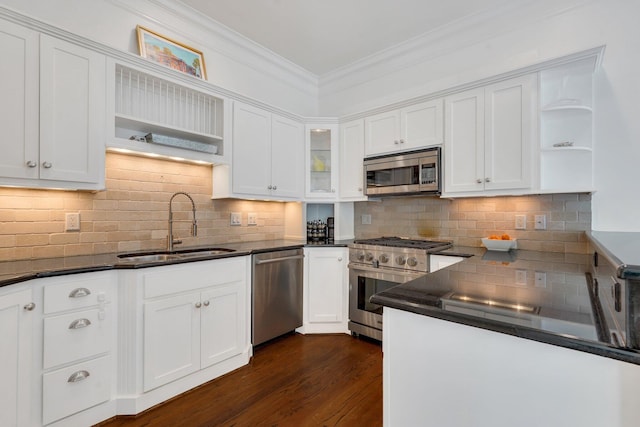 kitchen featuring open shelves, stainless steel appliances, a sink, dark countertops, and ornamental molding