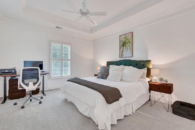 bedroom featuring ornamental molding, carpet flooring, a tray ceiling, a desk, and baseboards
