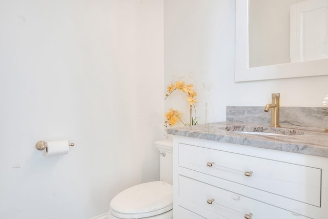 half bathroom with toilet and vanity