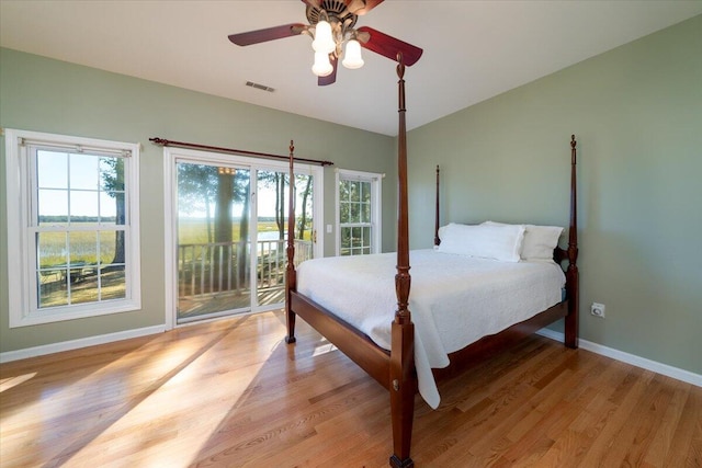 bedroom with ceiling fan, light hardwood / wood-style floors, and access to exterior