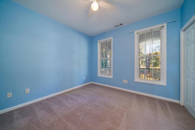 unfurnished room featuring carpet flooring and ceiling fan