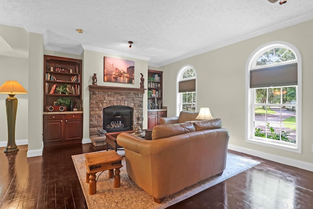 2494 Cape Rd, Johns Island, SC 29455 - living room with dark wood-style flooring, a stone fireplace, a textured ceiling, crown molding, and built in shelves