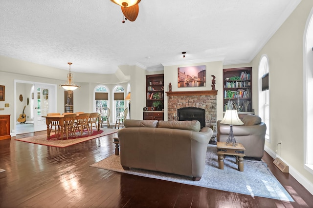 2494 Cape Rd, Johns Island, SC 29455 - living room with a fireplace, wood-type flooring, a textured ceiling, and ornamental molding