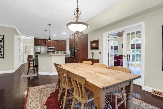 2494 Cape Rd, Johns Island, SC 29455 - dining room with dark wood finished floors, crown molding, a textured ceiling, and recessed lighting