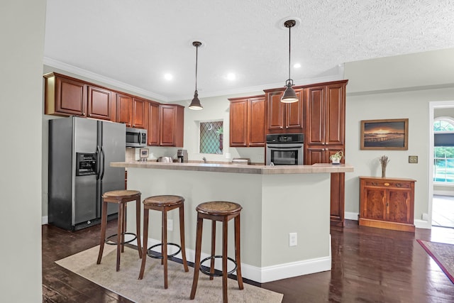 2494 Cape Rd, Johns Island, SC 29455 - kitchen featuring stainless steel appliances, a breakfast bar, light countertops, pendant lighting, and recessed lighting