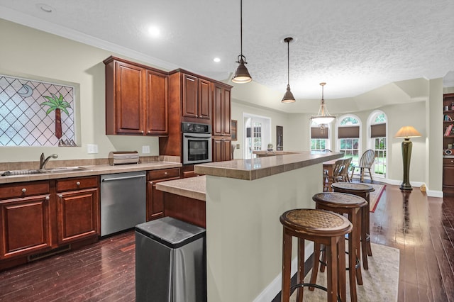2494 Cape Rd, Johns Island, SC 29455 - kitchen featuring stainless steel appliances, a breakfast bar, dark wood-style floors, pendant lighting, and a kitchen island