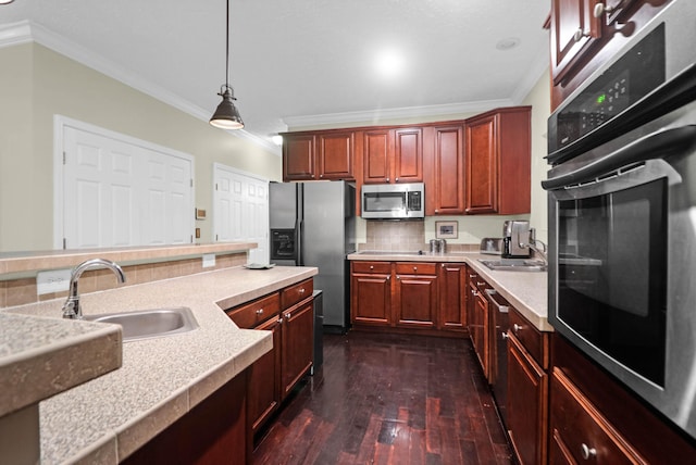 2494 Cape Rd, Johns Island, SC 29455 - kitchen featuring appliances with stainless steel finishes, crown molding, dark wood-style flooring, light countertops, and decorative light fixtures