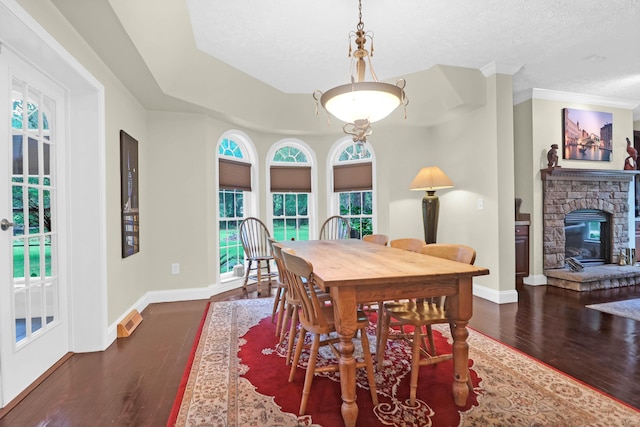 2494 Cape Rd, Johns Island, SC 29455 - dining space featuring dark wood-style floors, a stone fireplace, and a textured ceiling