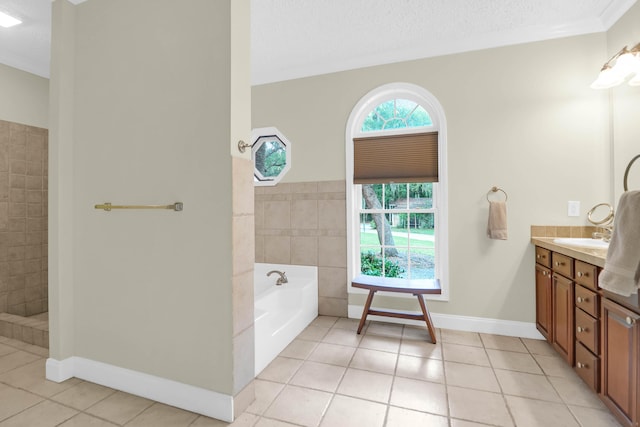 2494 Cape Rd, Johns Island, SC 29455 - bathroom with tile patterned flooring, vanity, a bath, a textured ceiling, and tiled shower
