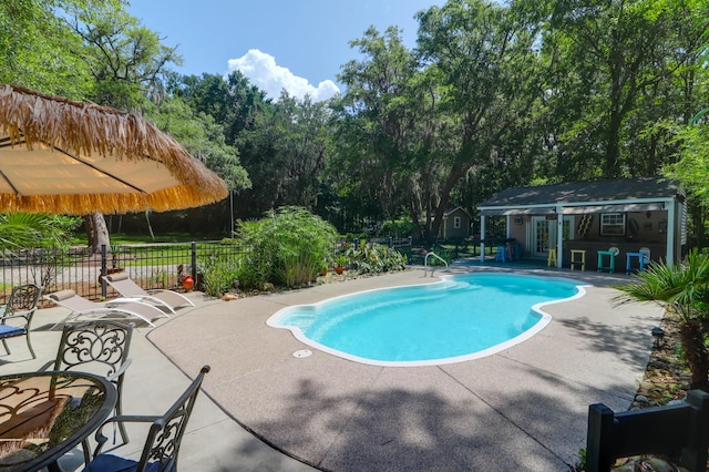 2494 Cape Rd, Johns Island, SC 29455 - view of pool featuring a patio, an outdoor structure, an exterior structure, and view of wooded area