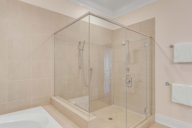 bathroom featuring crown molding and plus walk in shower